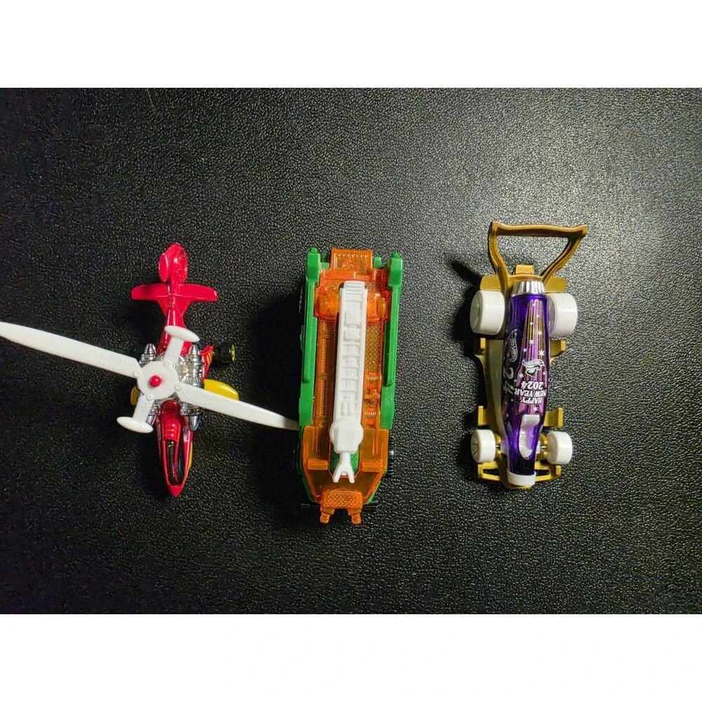 Lot of 4 loose Hot Wheels vehicles in pre-owned condition.